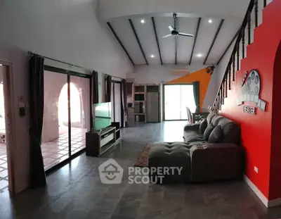 Spacious living room with modern design and large sliding doors leading to a terrace.