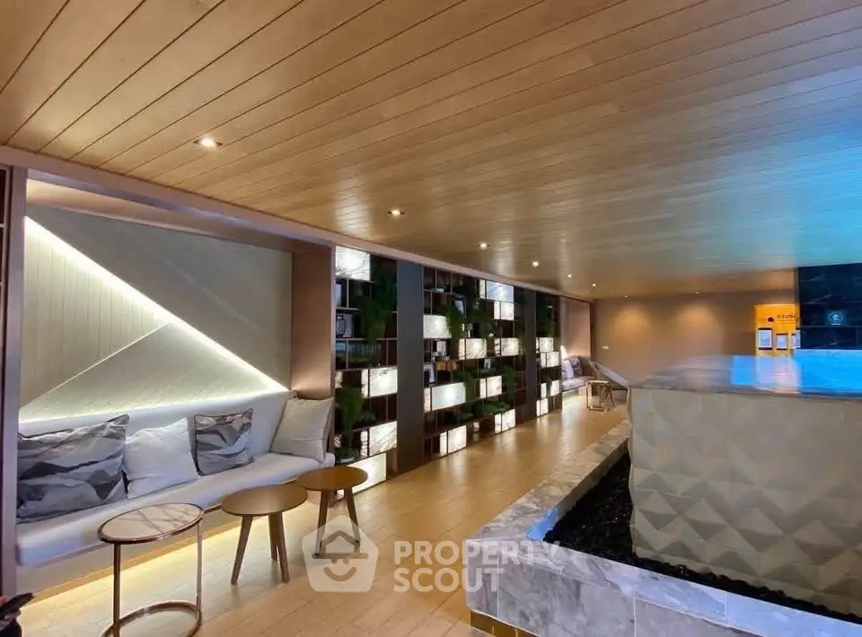 Luxurious modern interior with elegant seating and stylish lighting in a high-end real estate property.