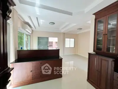 Spacious living room with elegant wooden furniture and large windows