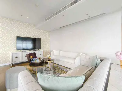 Luxurious living room with elegant sofas and large TV, perfect for relaxation and entertainment.