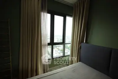 Cozy bedroom with large window offering a stunning city view, complemented by elegant curtains and a comfortable bed.