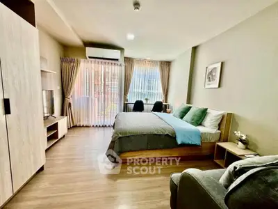 Spacious modern bedroom with large windows and stylish decor