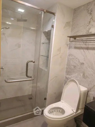 Modern bathroom with glass shower and elegant marble tiles