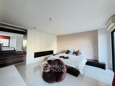 Spacious modern bedroom with elegant decor and ample storage space