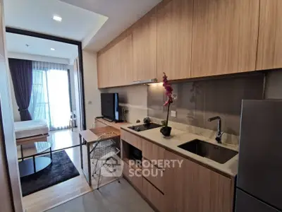 Modern studio apartment with sleek kitchen and cozy living area