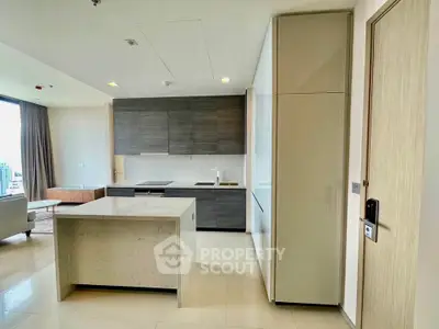 Modern open-layout kitchen with sleek cabinetry and island in a bright apartment.