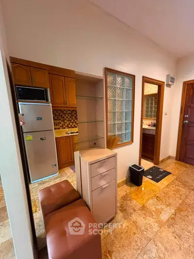 Charming kitchen with closed layout and modern appliances in cozy apartment.