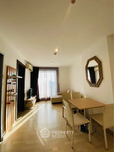 Bright and spacious living room with modern furniture and large window view.