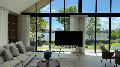 Luxurious living room with stunning waterfront view and modern decor