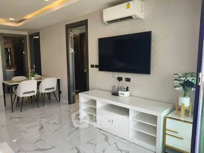 Modern living room with sleek TV setup and elegant dining area