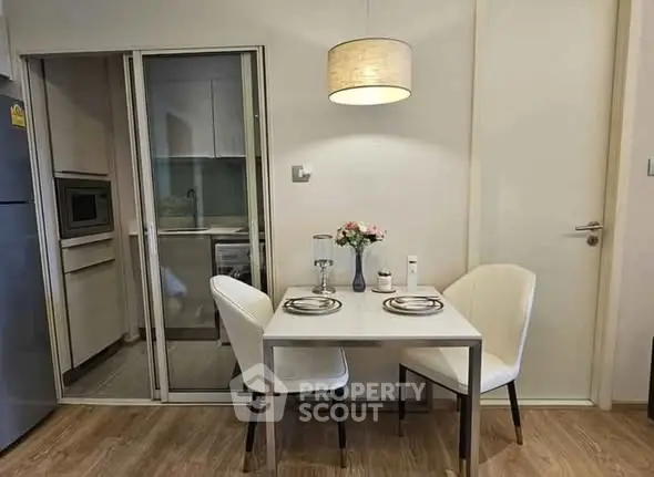 Cozy dining area with modern kitchen and elegant lighting
