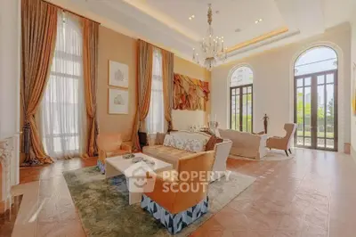 Luxurious living room with high ceilings, elegant drapes, and stylish furniture in a spacious open layout.