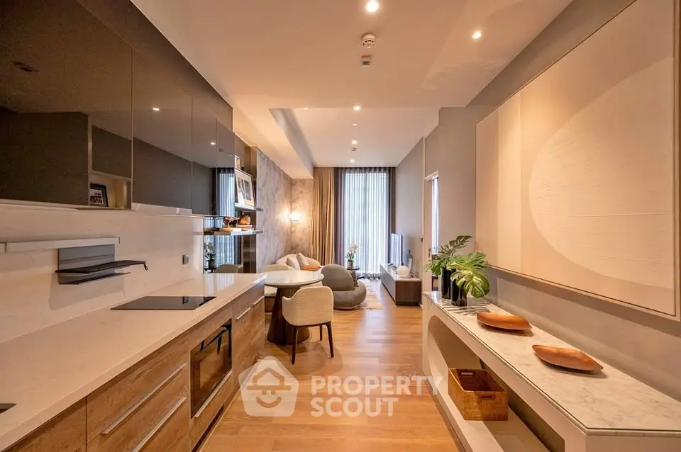 Luxurious open-plan kitchen and living room with modern decor and elegant lighting.