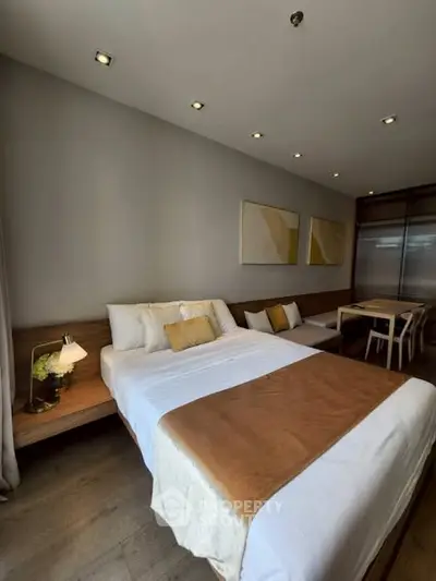 Modern bedroom with stylish decor and cozy ambiance, featuring a comfortable bed and elegant furnishings.