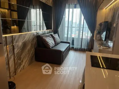 Modern living room with sleek design, large windows, and stylish furnishings in a high-rise apartment.