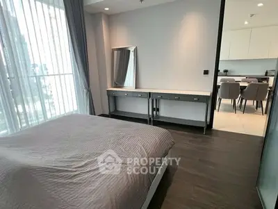 Modern bedroom with stylish decor and open view to dining area