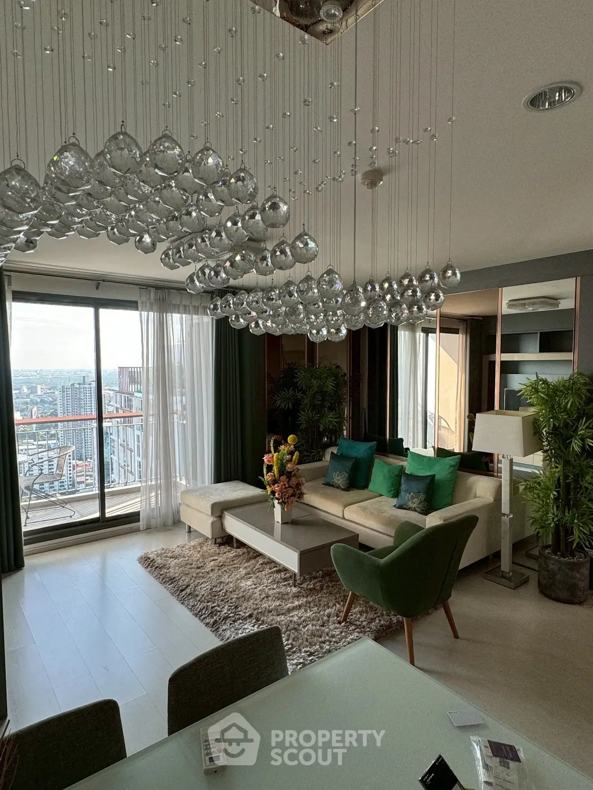 Luxurious living room with stunning city view and elegant chandelier