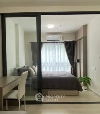 Modern bedroom with glass partition and cozy decor in urban apartment