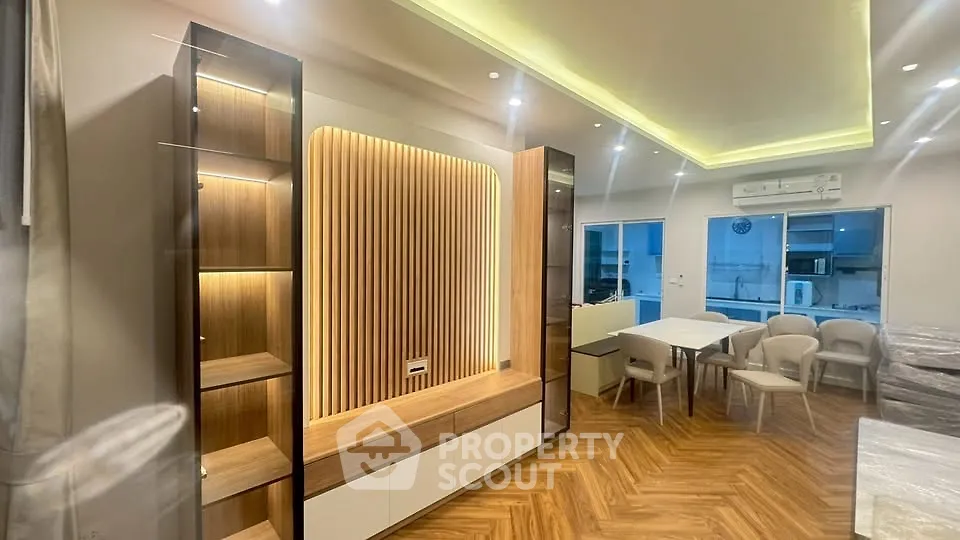 Modern living room with elegant wood paneling and ambient lighting