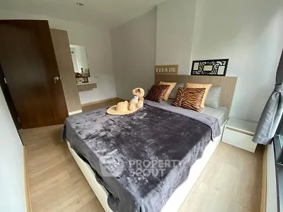 Cozy bedroom with modern decor and large window for natural light