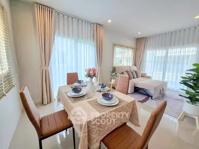 Elegant dining and living area with natural light and modern decor