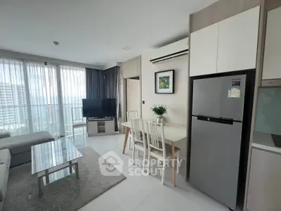 Modern living room with dining area and balcony view in a stylish apartment.