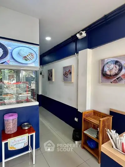 Charming restaurant interior with modern decor and food displays, perfect for a cozy dining experience.