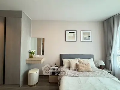 Modern bedroom with stylish decor and large window offering natural light