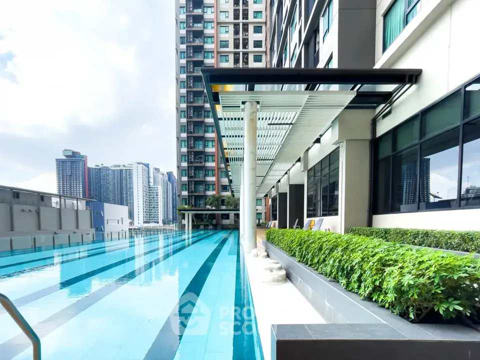 Luxurious high-rise building with stunning outdoor pool and city view, perfect for urban living.
