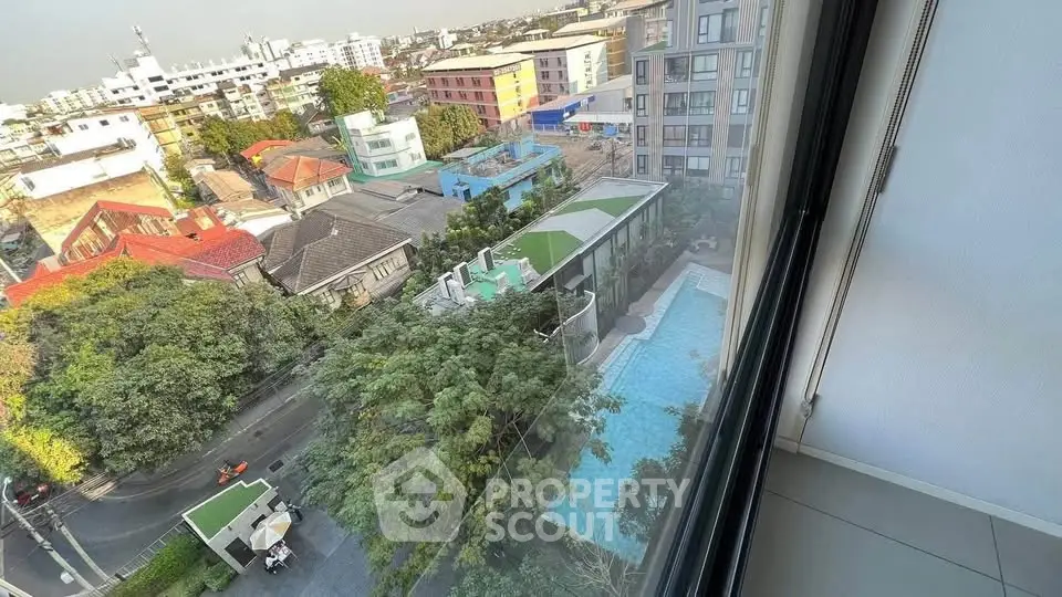 Stunning high-rise view with pool and lush greenery in urban setting