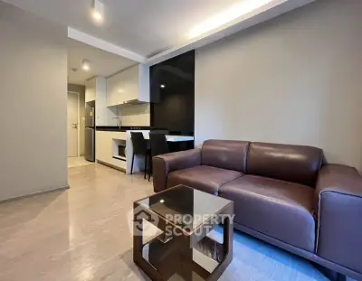 Modern living room with sleek kitchen and stylish furniture in open layout apartment.
