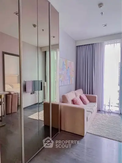 Modern living room with mirrored closet and cozy sofa in bright apartment