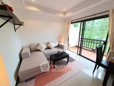 Charming living room with cozy sofa and balcony view, perfect for relaxation and entertaining.