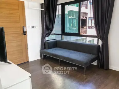 Modern living room with sleek sofa and large window view