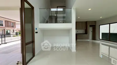 Modern open-plan living area with high ceilings and sleek kitchen design