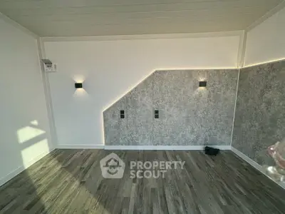 Modern interior with stylish lighting and textured wall in a contemporary room.