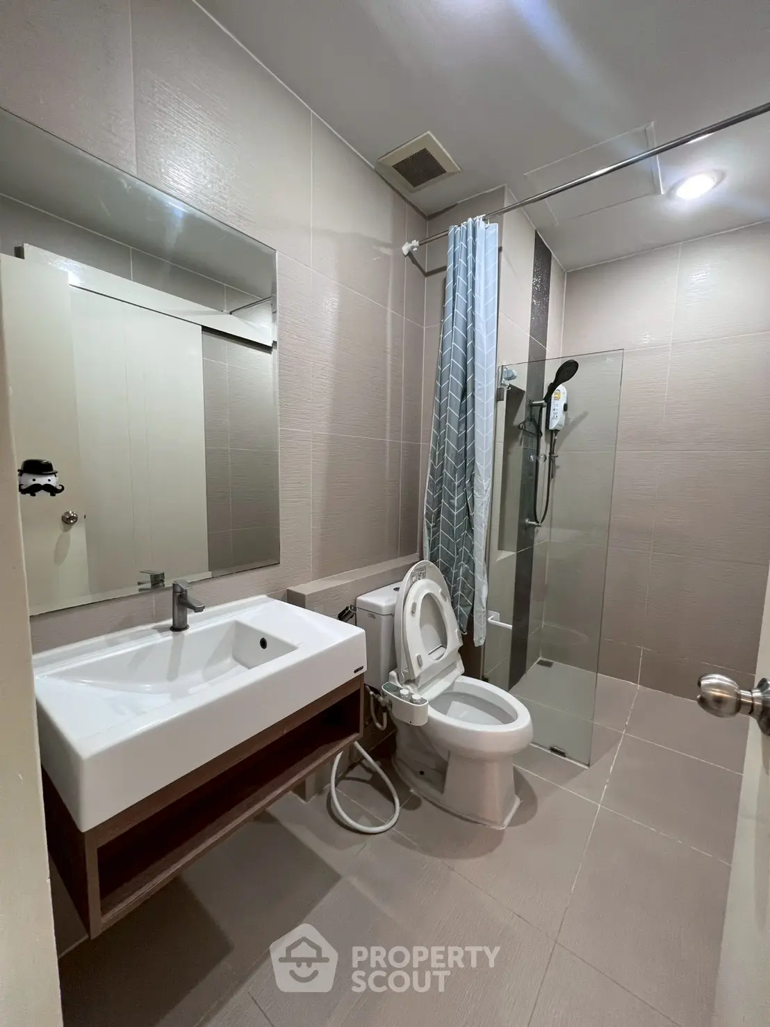 Modern bathroom with sleek fixtures and glass shower enclosure