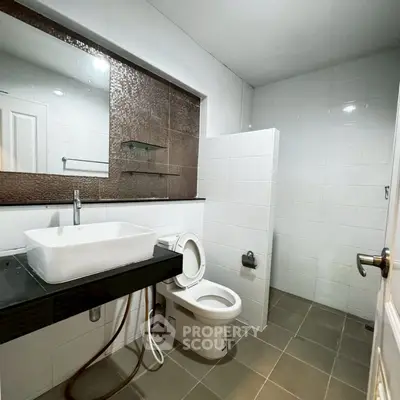 Modern bathroom with sleek fixtures and large mirror