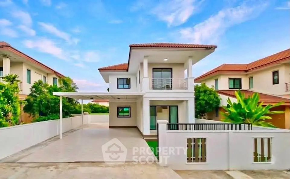Stunning modern two-story house with spacious driveway and lush greenery in a serene neighborhood.