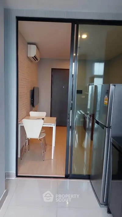 Modern kitchen with sleek appliances and dining area in stylish apartment