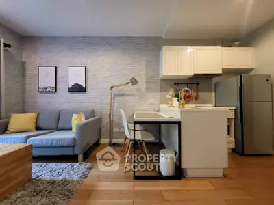 Modern open-layout living room with stylish kitchen and cozy seating area, perfect for urban living.