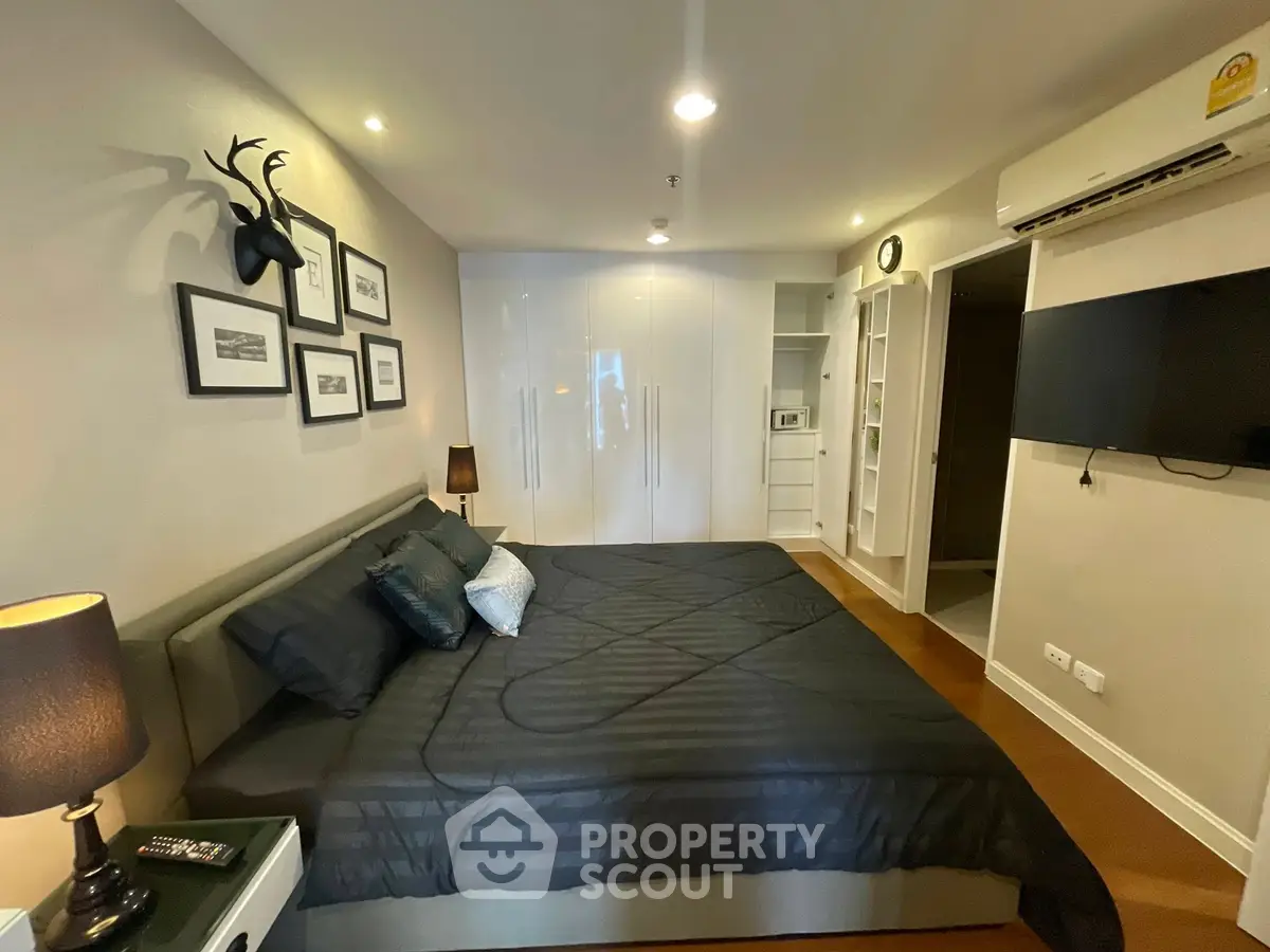 Modern bedroom with stylish decor and ample storage space