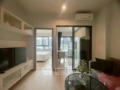 Modern living room with open view to bedroom and cityscape