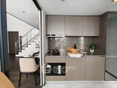 Modern kitchen with sleek cabinetry and integrated appliances in a stylish apartment.