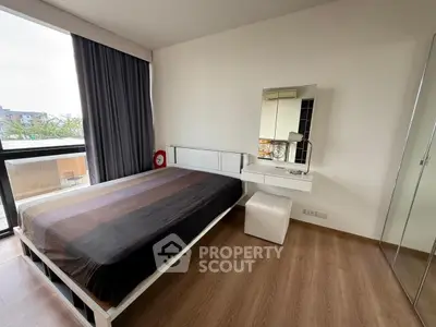 Modern bedroom with large window and stylish decor