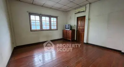 Spacious empty room with wooden floors and natural light, ideal for customization.
