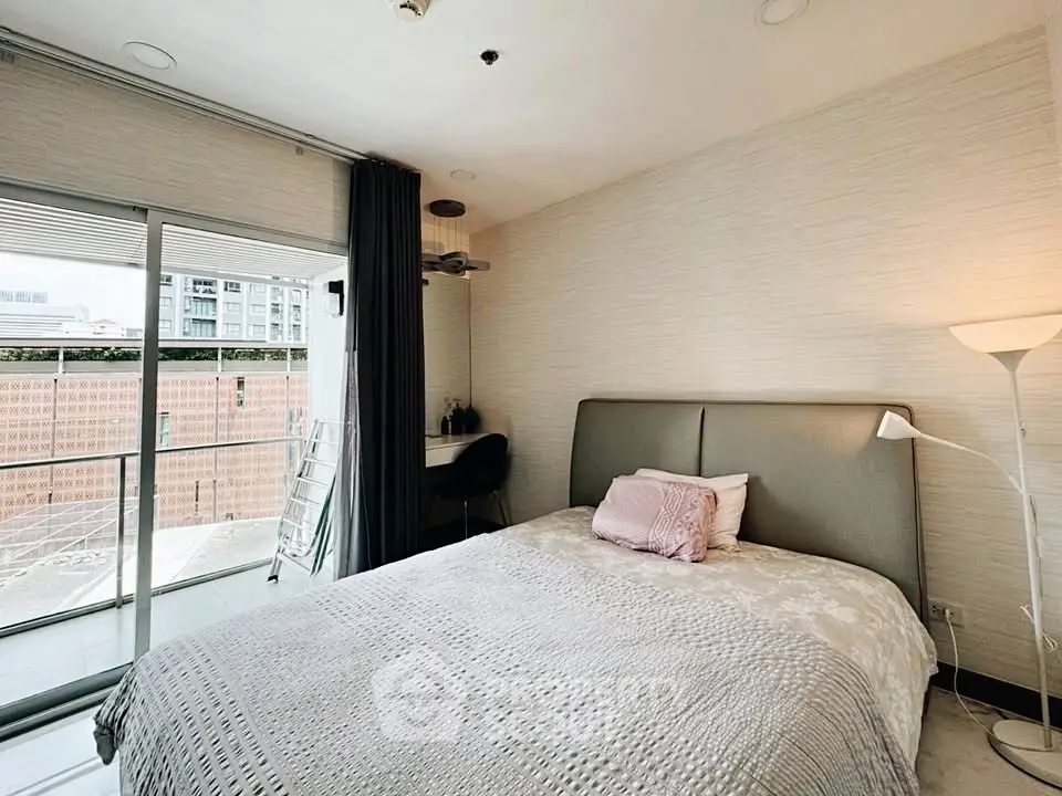 Modern bedroom with balcony access in urban apartment