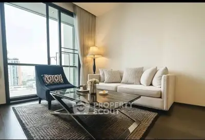 Modern living room with stylish furniture and large windows offering city views.