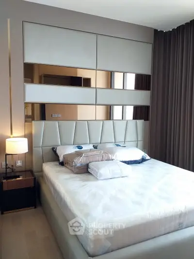 Luxurious modern bedroom with elegant decor and plush bedding in a stylish apartment.