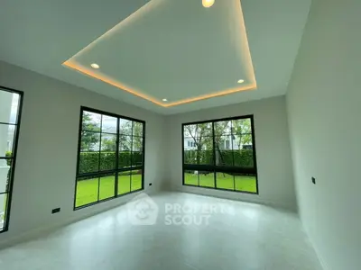 Spacious modern room with large windows and garden view
